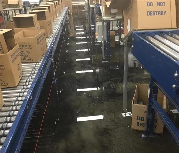 Water on the floor of a large warehouse